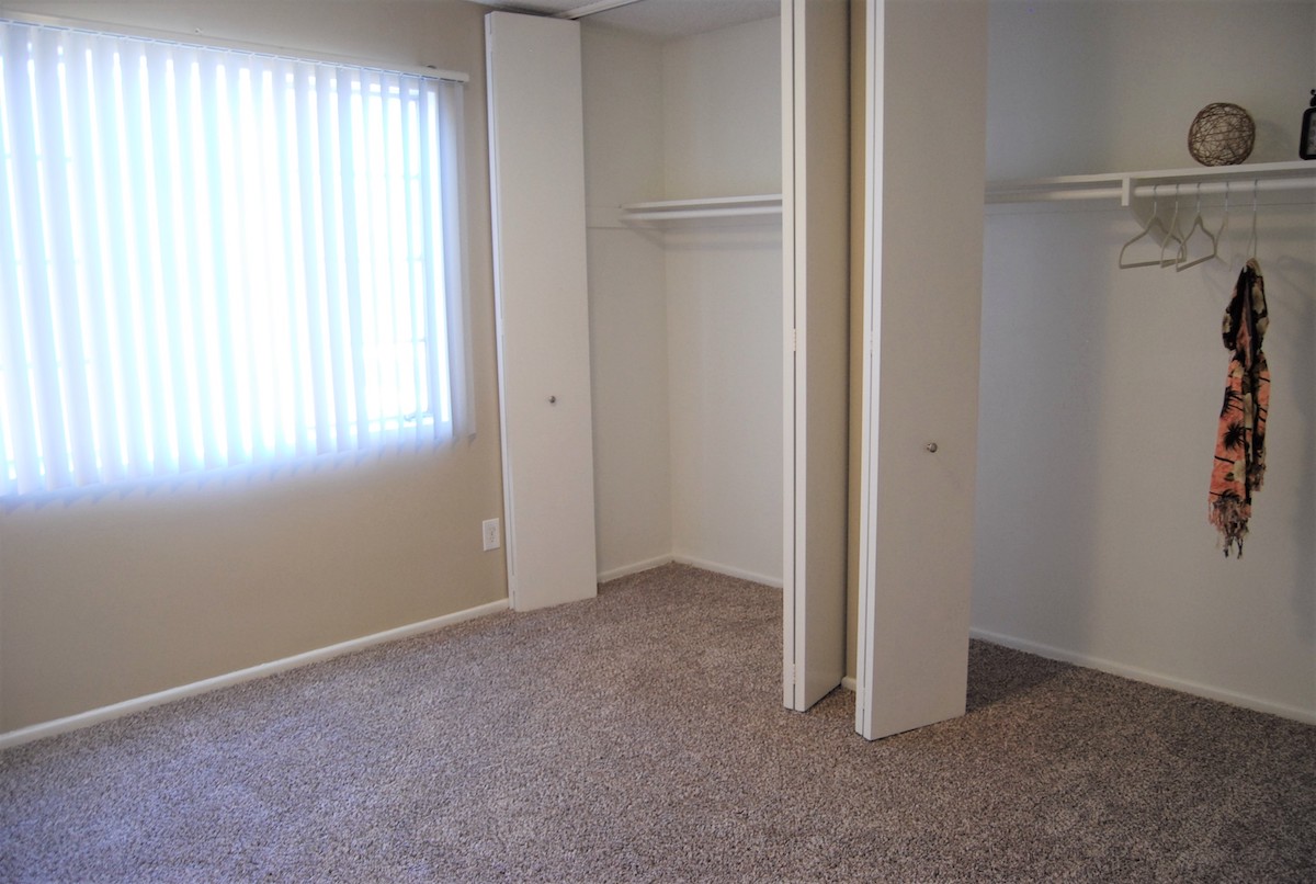 Bedroom with plush carpeting. Large walk-in closets in the bedroom.